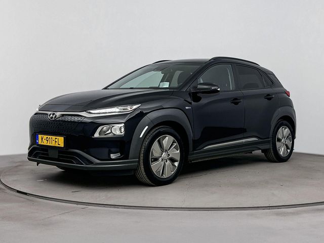Hyundai Kona EV FASHION 64 kWh | DODEHOEK DETECTIE | PDC | 3 FASEN | WARMTEPOMP | CAMERA | CLIMA | CRUISE ADAPT. | NAVI | STOELVERWARMING | STUURVERWARMING | PRIVACY GLASS |
